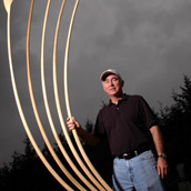 Marshall University sculpture professor Jonathan Cox with his sculpture The Idea at the 2005 Snowshoe Institute, at Snowshoe, WV.  Portrait Photogrpahy by Alex Wilson.